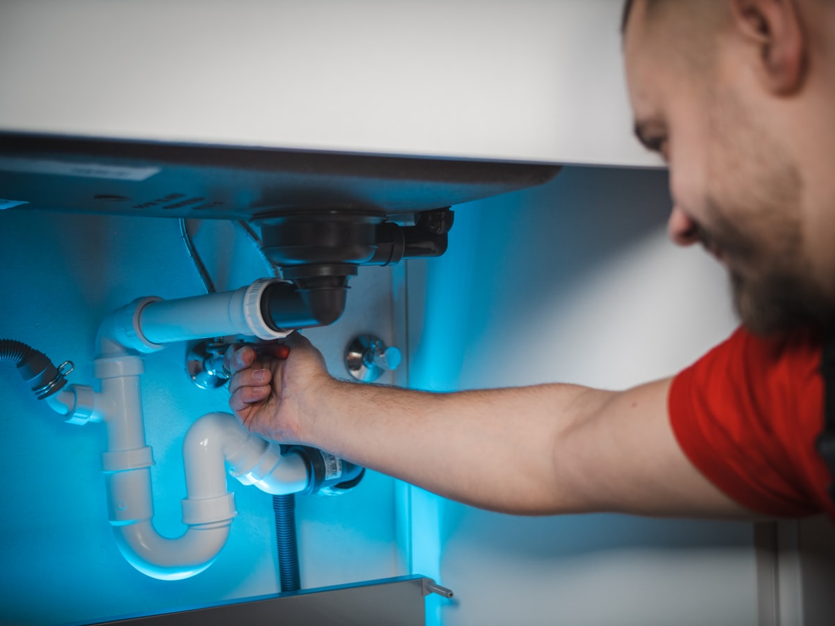 Plumber checking an under-sink installation